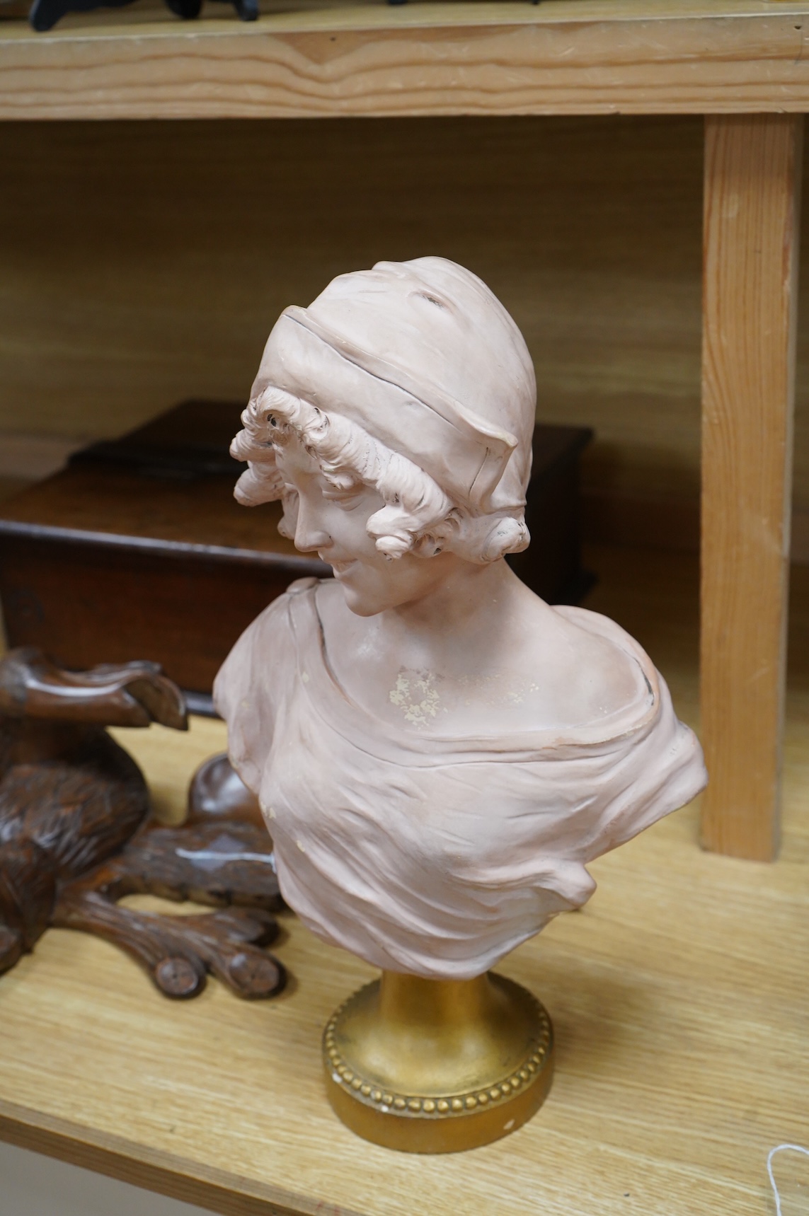A painted terracotta bust of a maiden, indistinctly signed and numbered 1320, 41cm high